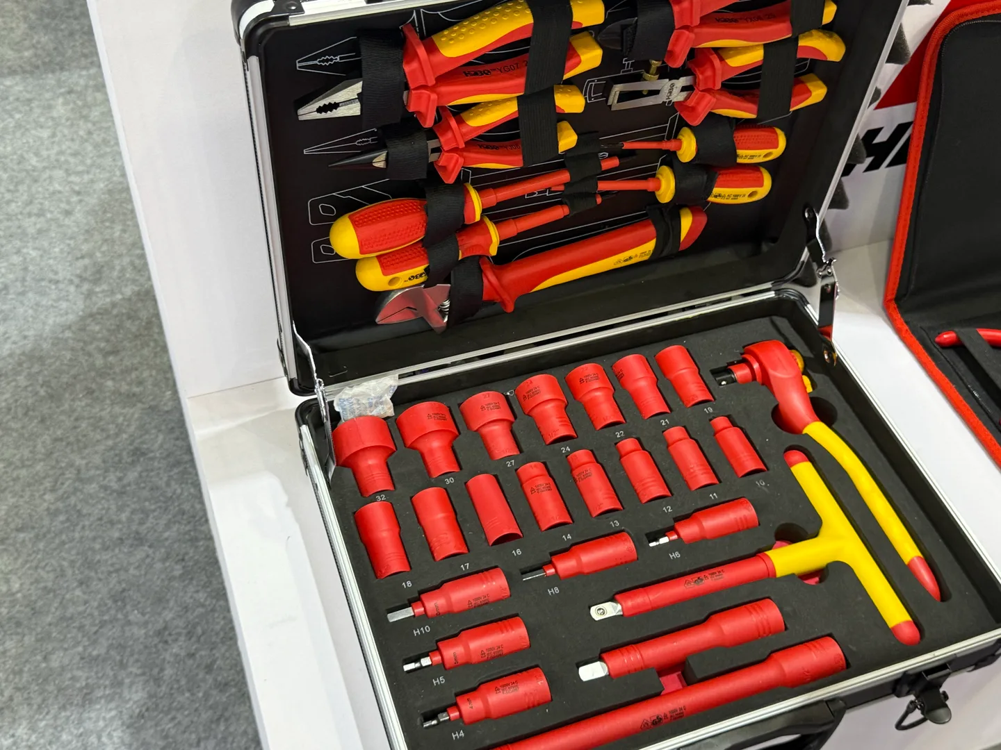 Sockets, a ratchet and other hand tools arranged inside an open carrying case